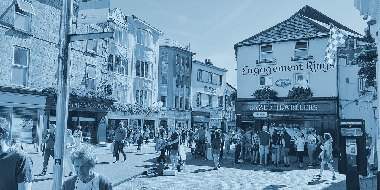 Shopfronts and pedestrians on Shop Street in Galway on a sunny day