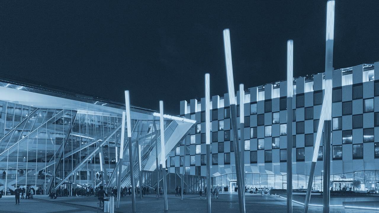 Grand Canal Square in Dublin at night, lit red light-stalks outside the glass theatre and offices